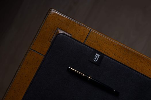 wooden backdrop with a black mousepad